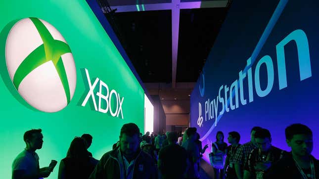 Fans walk between dueling Xbox and PlayStation logos. 